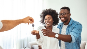 Happy couple accepting new house keys